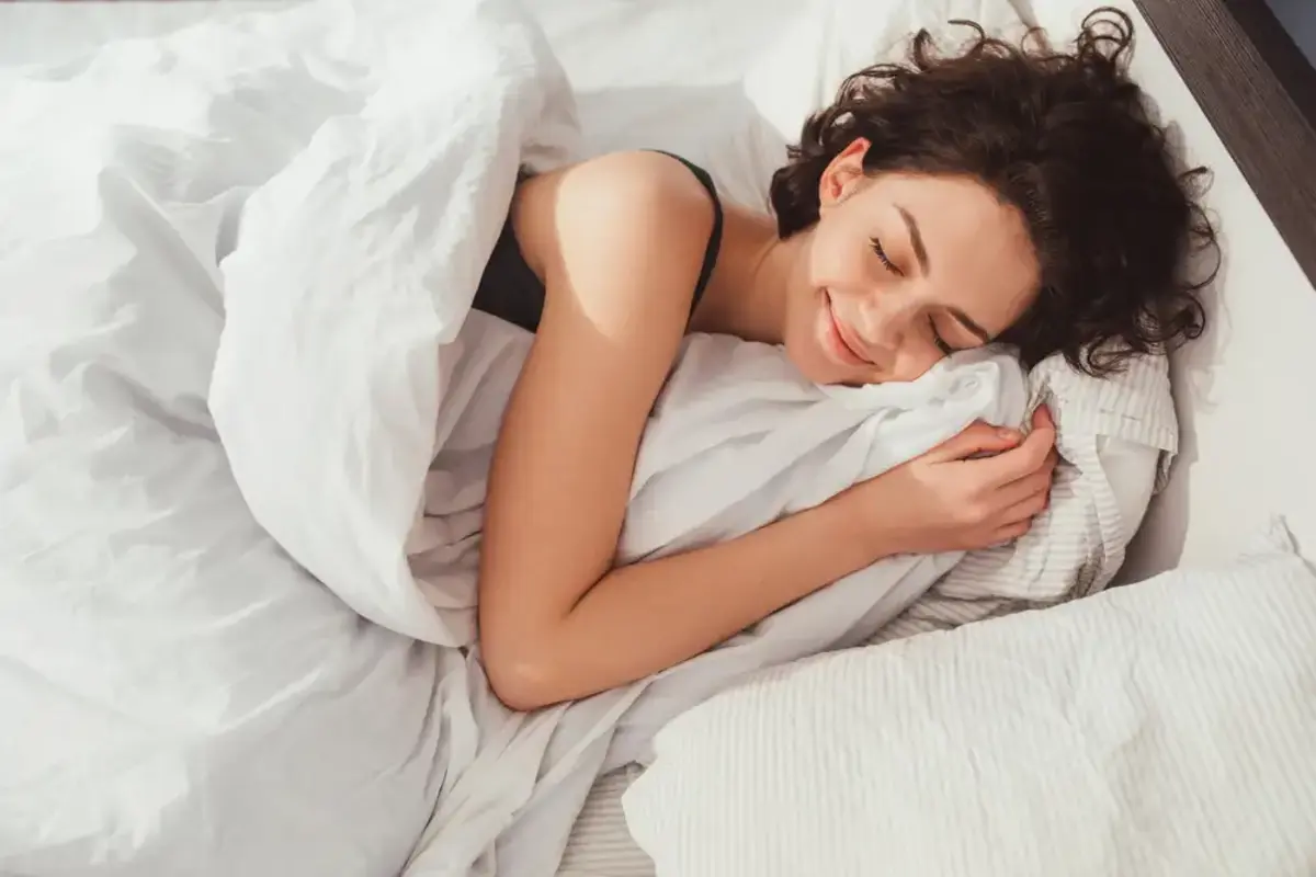 young woman happily sleeping