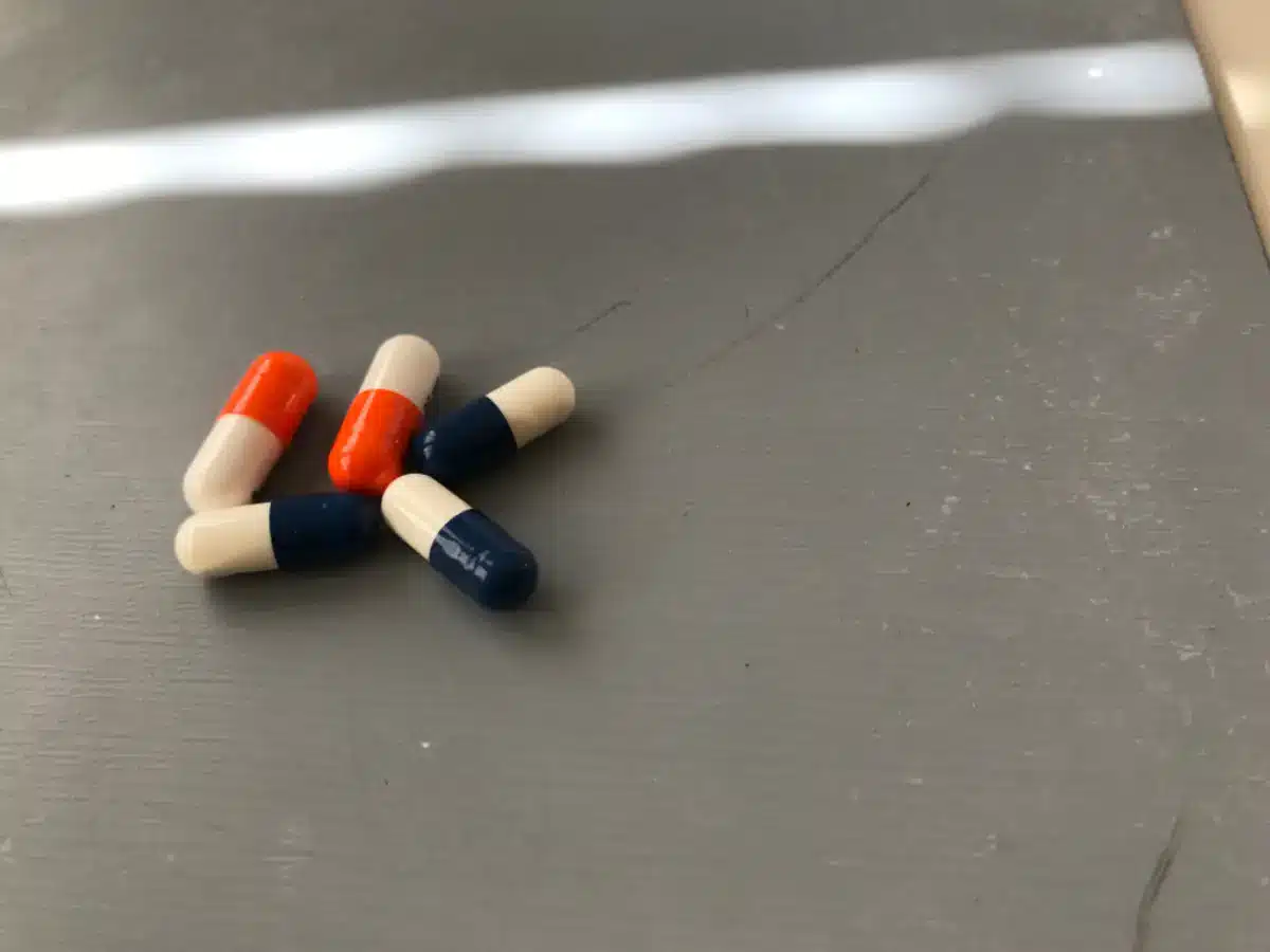 Blue and white and orange and white pills