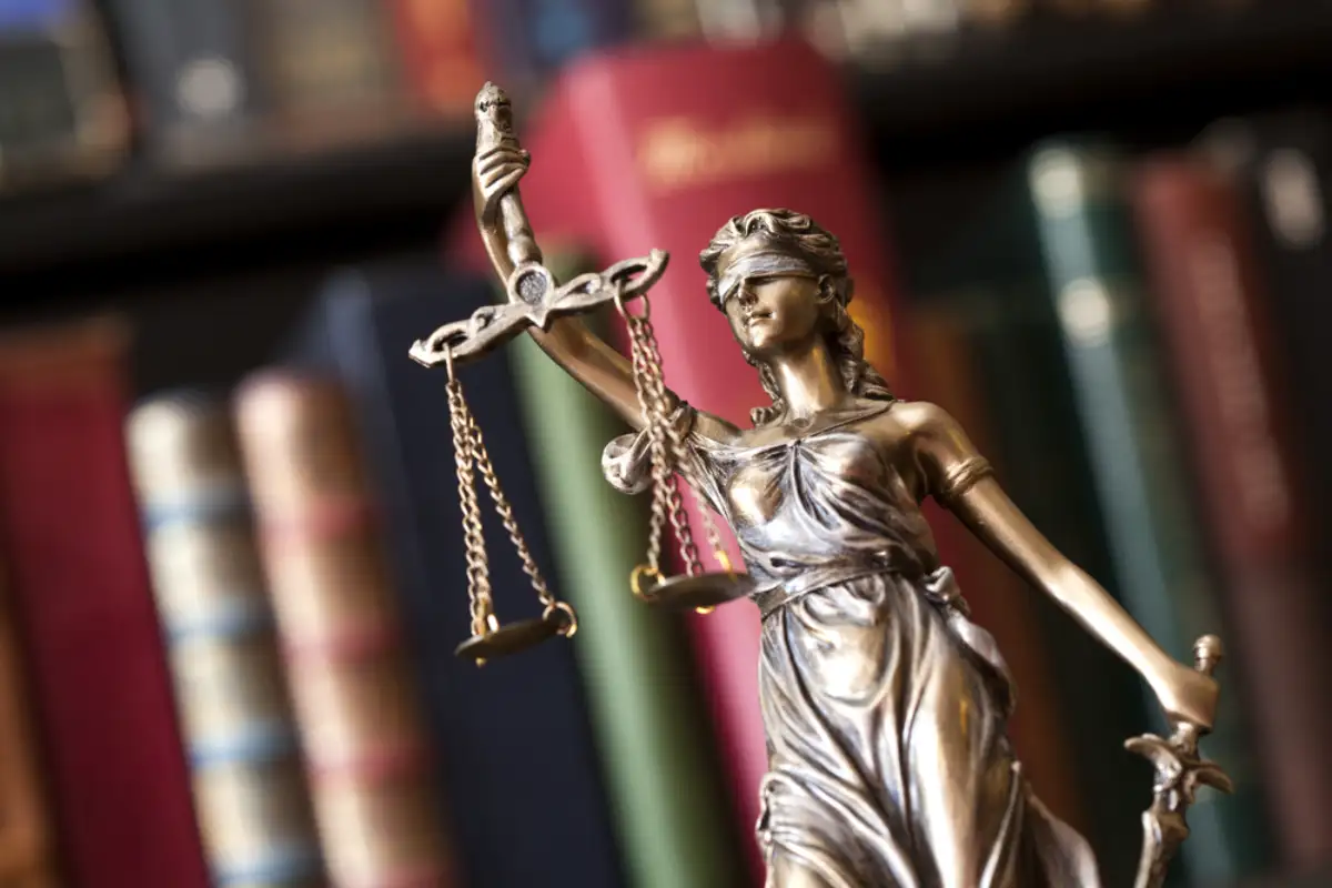 Lady Justice with books on the background