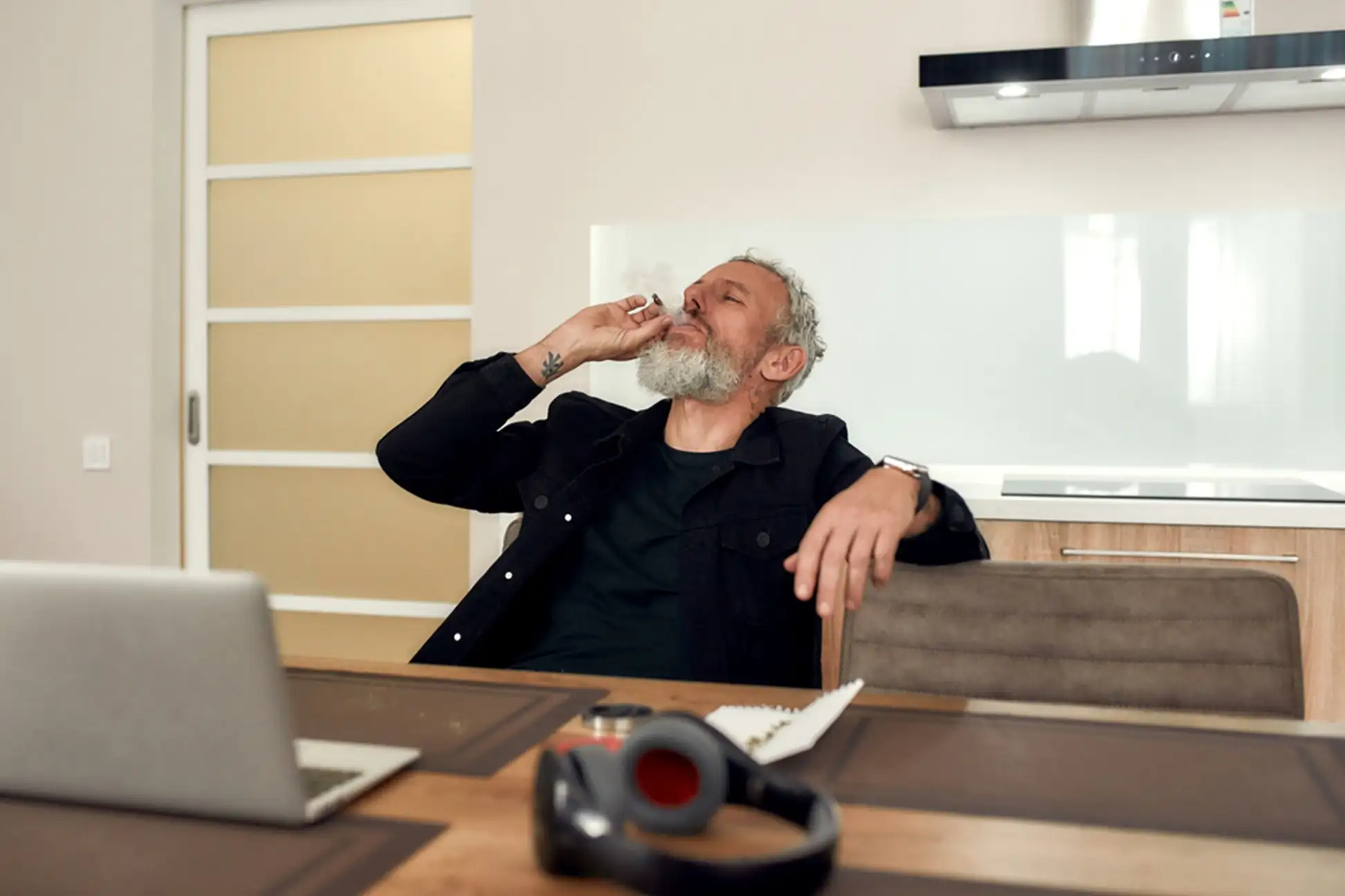 Man sitting at a table smoking