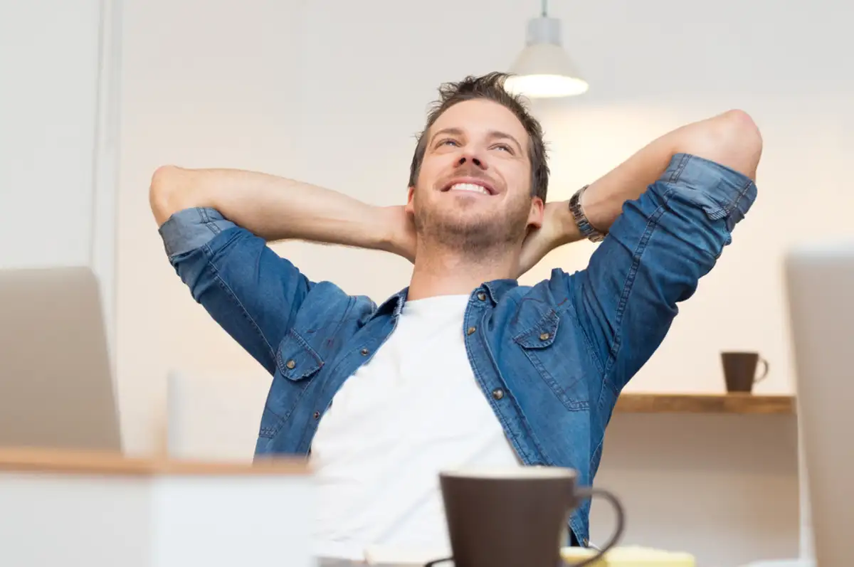 Man sitting in front of a laptop relaxing