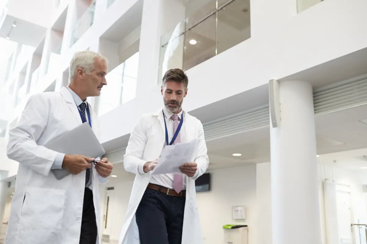 Two doctors talking as they walk through hospital