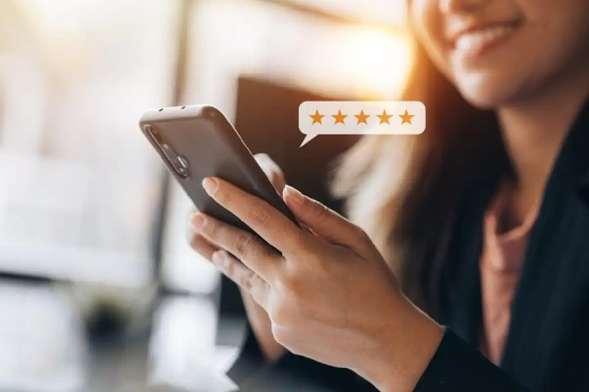 Woman holding a smart phone giving reviews