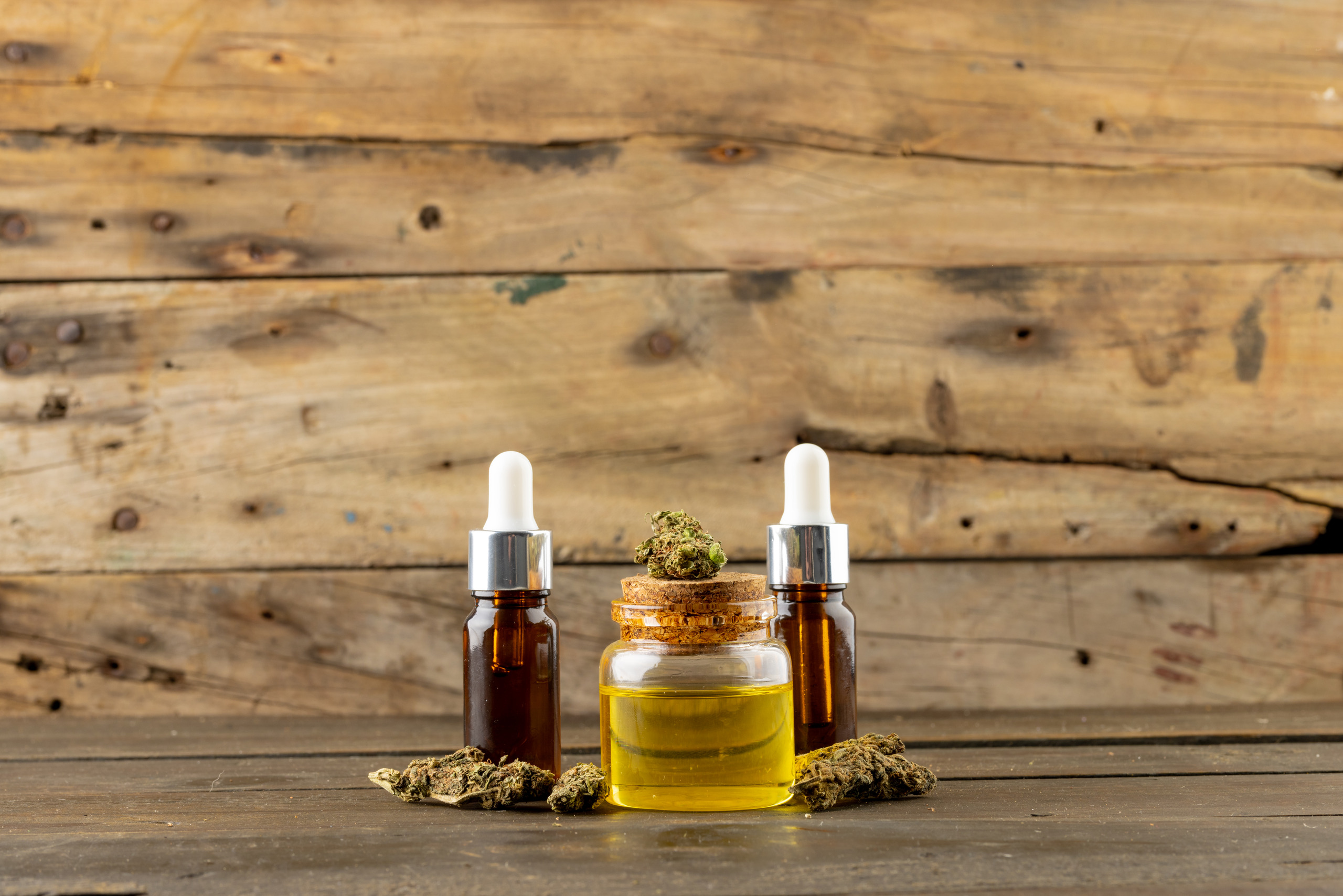 image of cbd oil in bottle on wooden background 